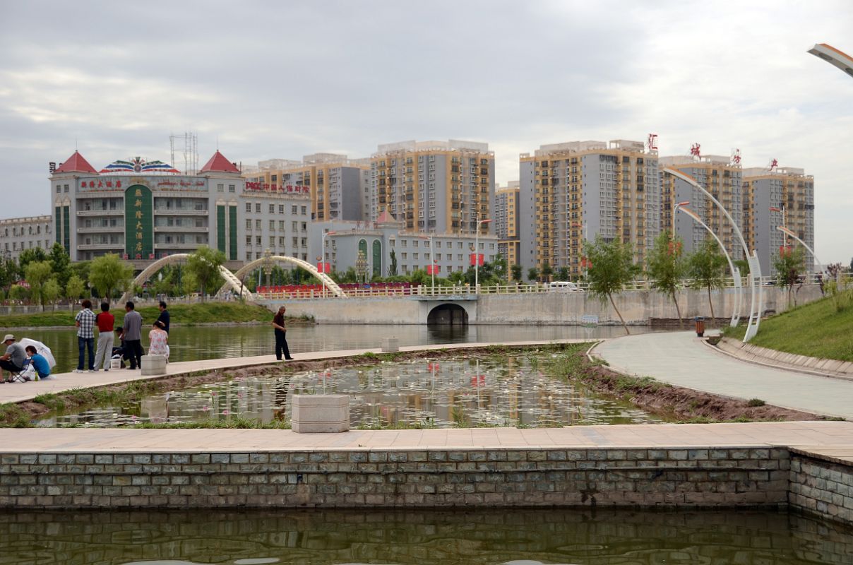 20 Kashgar Donghu East Lake Lotus Pond With Modern Buildings Behind